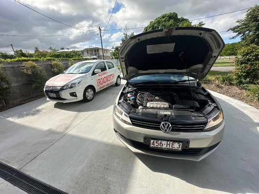Car and VW Polo being inspected: A professional mechanic performs a thorough safety inspection on both a car and a VW Polo, ensuring they meet standards for a Brighton Mobile Roadworthy (Safety Certificate).