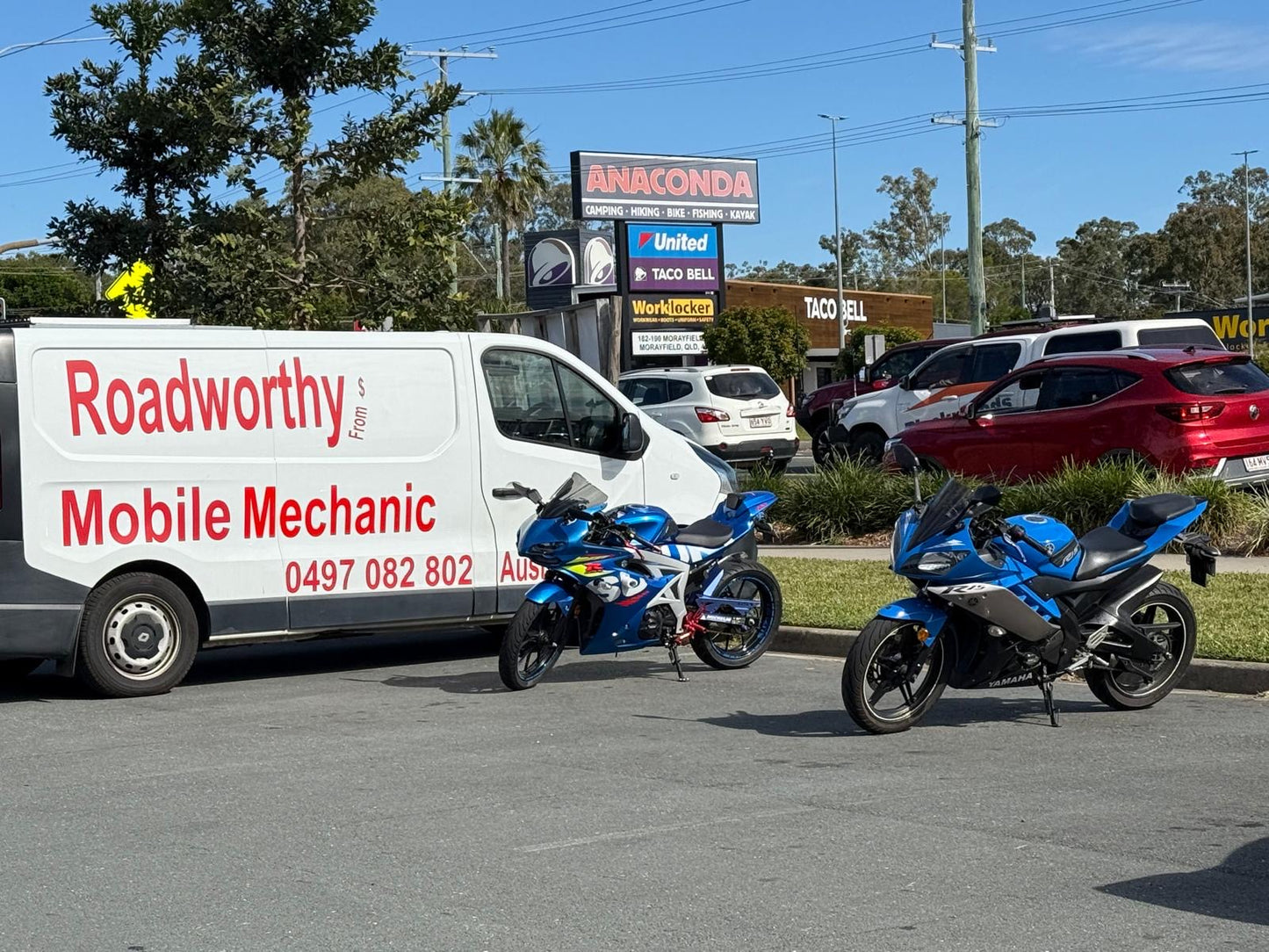 Expert Albany Creek Mobile Roadworthy (Safety Certificate) inspection for two motorcycles, ensuring thorough RWC checks for safety. Roadworthy Mobile Mechanic van with two blue motorcycles on a road.