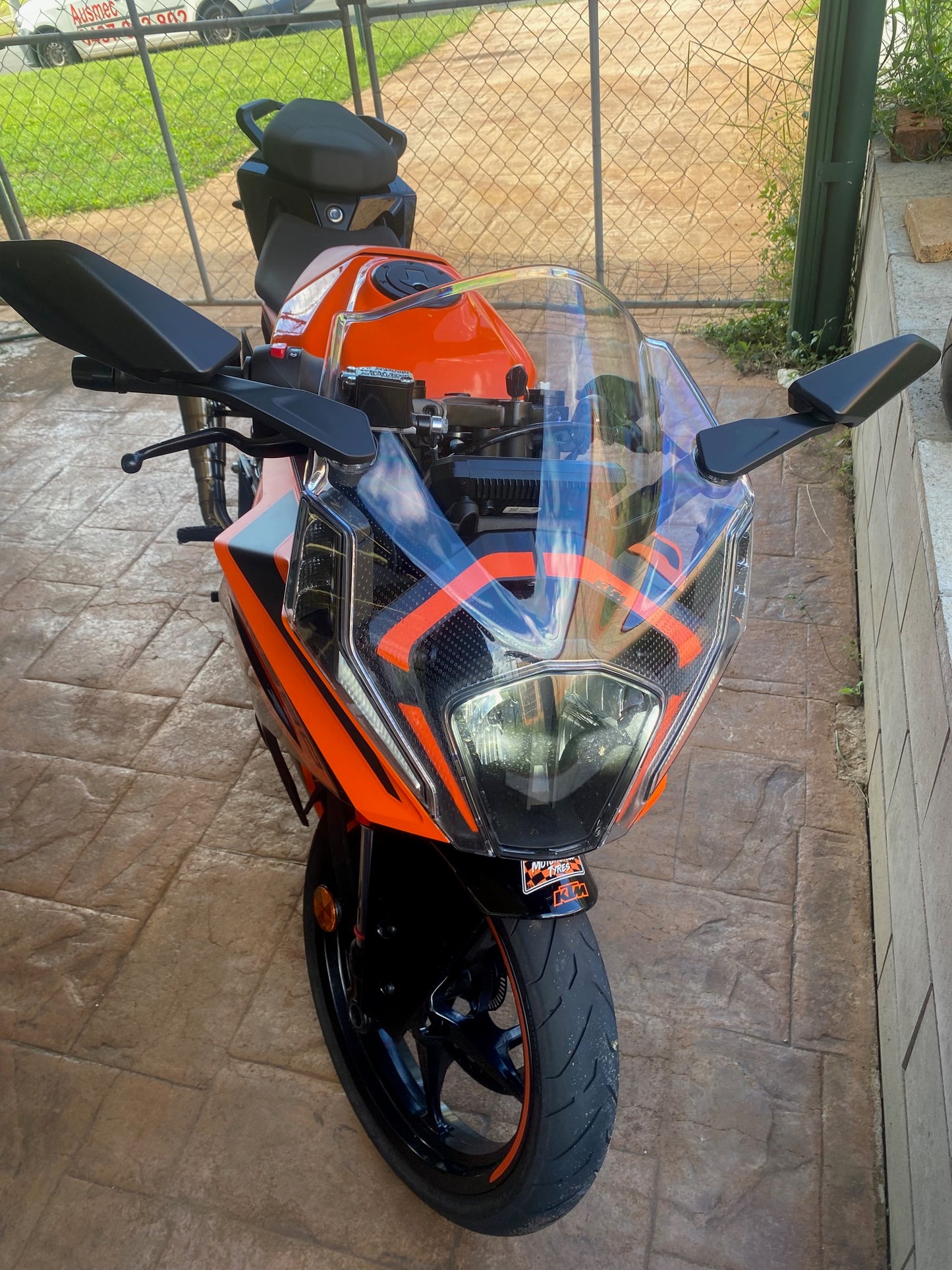 Motorcycle ready for inspection in driveway
Alt text: Motorcycle parked in a driveway, ready for a convenient Bald Hills Mobile Roadworthy (Safety Certificate) inspection from Ausmec. Motorcycle with a clear windshield on a stone patio