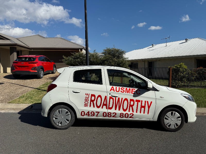Inspection vehicle parked at inspection location
Alt text: Ausmec Mobile Roadworthy inspection vehicle parked on-site in Bald Hills, ready to perform a Mobile Roadworthy (Safety Certificate) at your location. White car with red text and phone number on a residential street