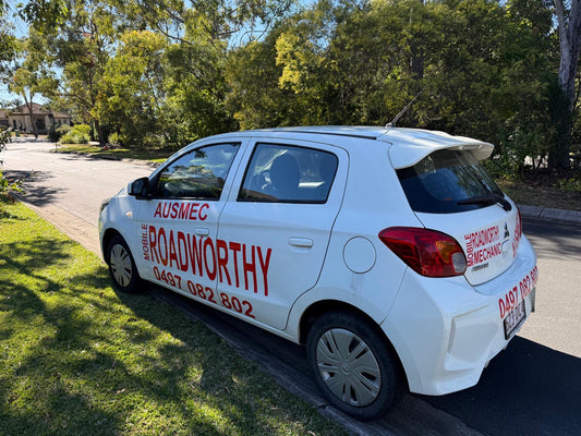 (Mobile AIS ready to inspect car): Boondall Mobile Roadworthy (Safety Certificate) - Your car, inspected on-site. White car with 'Ausmec Roadworthy' branding parked on a street.