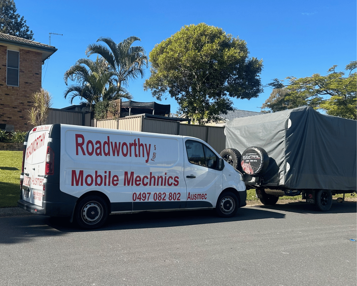 "Thorough caravan inspection for a Caboolture Mobile Roadworthy (Safety Certificate) completed on the customer's property." White van with 'Roadworthy Mobile Mechanics' branding parked on a street.