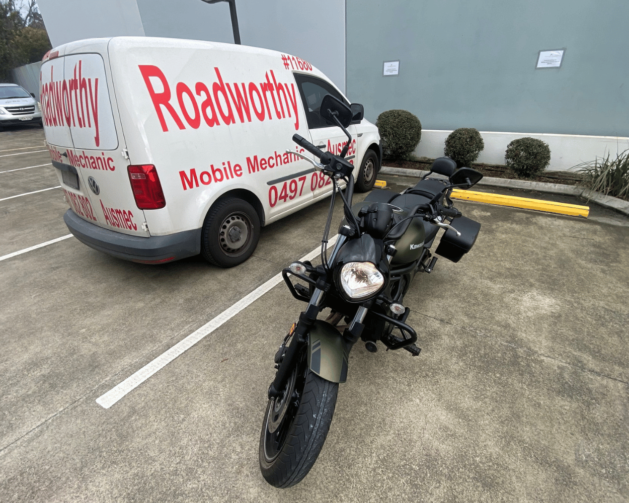 Don't trailer your bike! We provide Chermside West Mobile Roadworthy (Safety Certificate) services for motorcycles and mopeds, inspecting them conveniently in your parking lot or a suitable area. White van with 'Roadworthy' branding and a motorcycle in a parking lot.