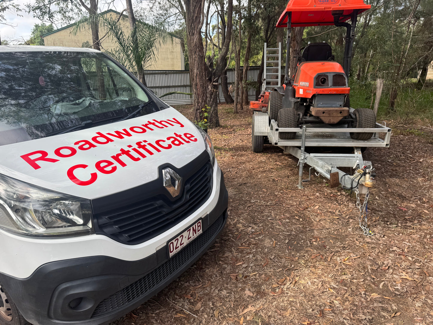 "Comprehensive Kallangur Mobile Roadworthy (Safety Certificate) for a utility trailer, delivered conveniently at the customer's location." White van with 'Roadworthy Certificate' text and a red tractor on a trailer in an outdoor setting.