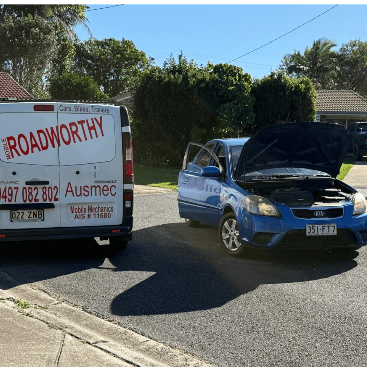 Ausmec technician inspecting a blue Kia with an open bonnet for a Deception Bay Roadworthy (Safety certificate).