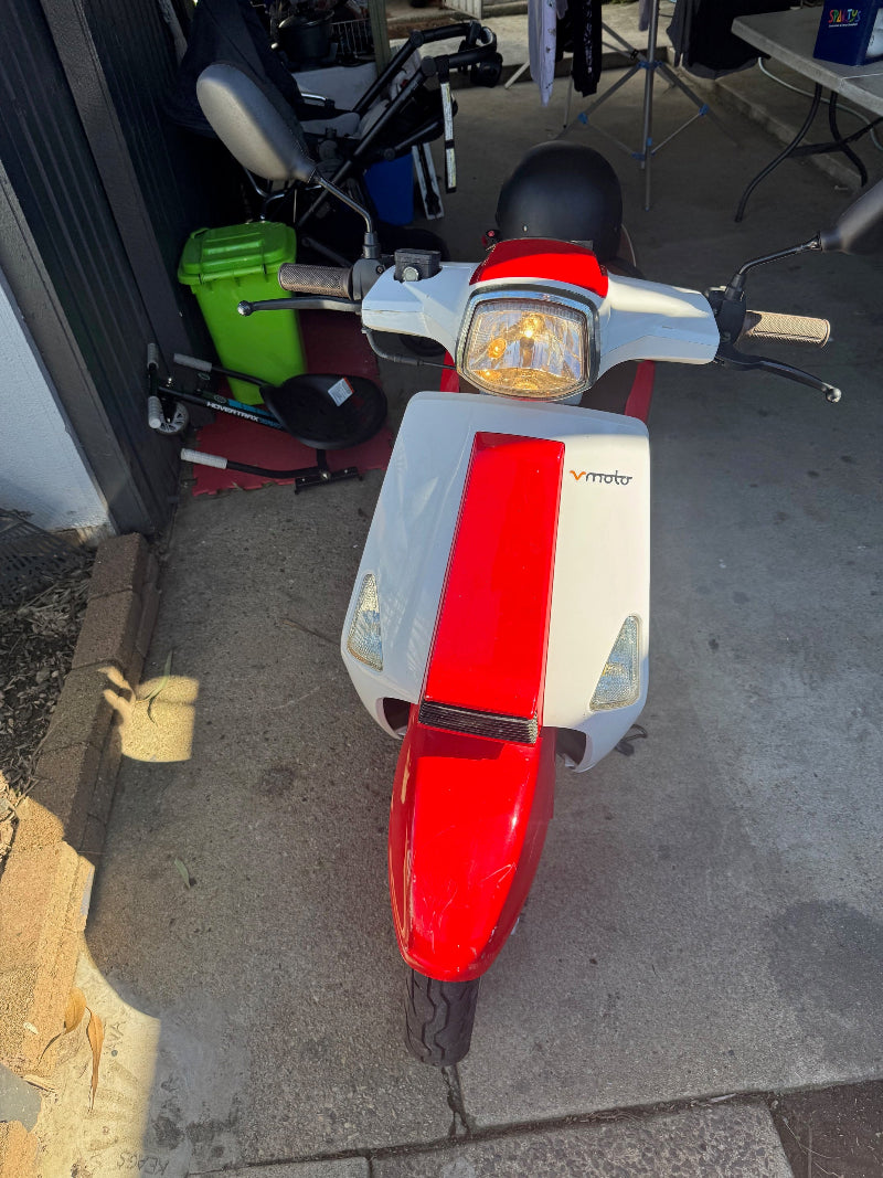 Licensed inspector checking moped for QLD safety certificate.