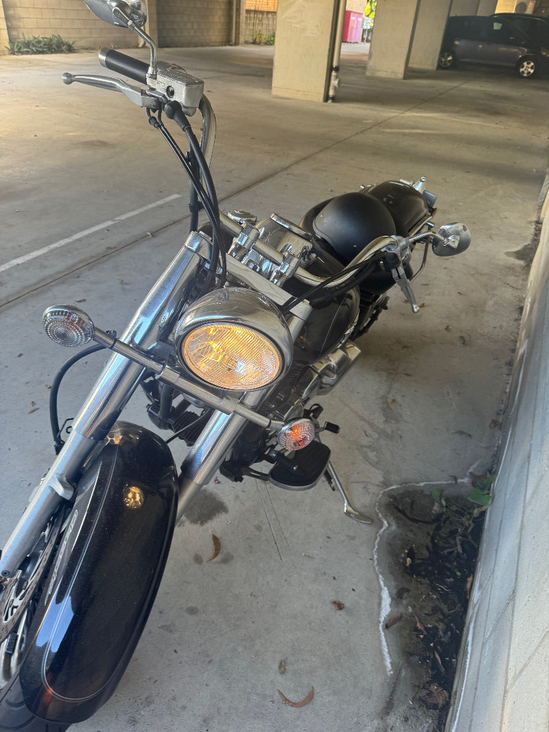 A motorcycle awaits its Margate Roadworthy (Safety Certificate) inspection in the basement."