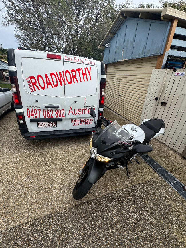 A mechanic performing an inspection on a car, emphasizing the Murrumba Downs Roadworthy (Safety Certificate) process.