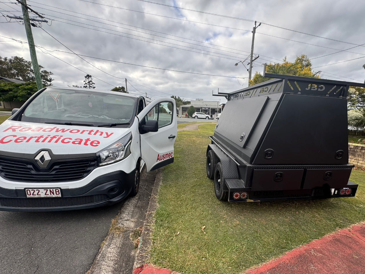 A black box trailer is inspected for its Margate Roadworthy (Safety Certificate), with our roadie van positioned nearby."