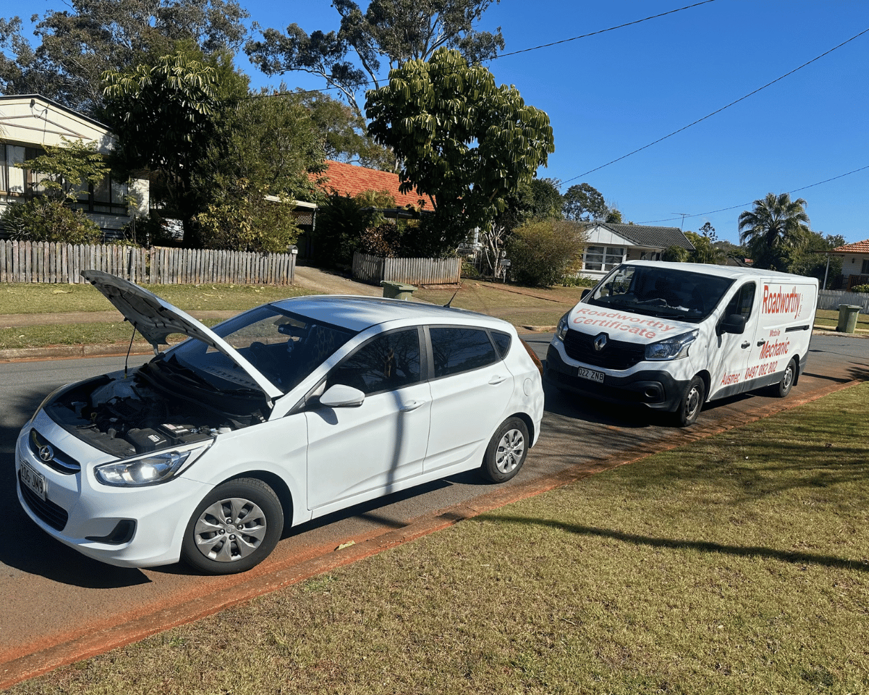 "Convenient Burpengary Mobile Roadworthy (Safety Certificate) for a car being conducted by an Ausmec mechanic at a customer's home." White car with open hood on a driveway next to a van with a visible brand logo.