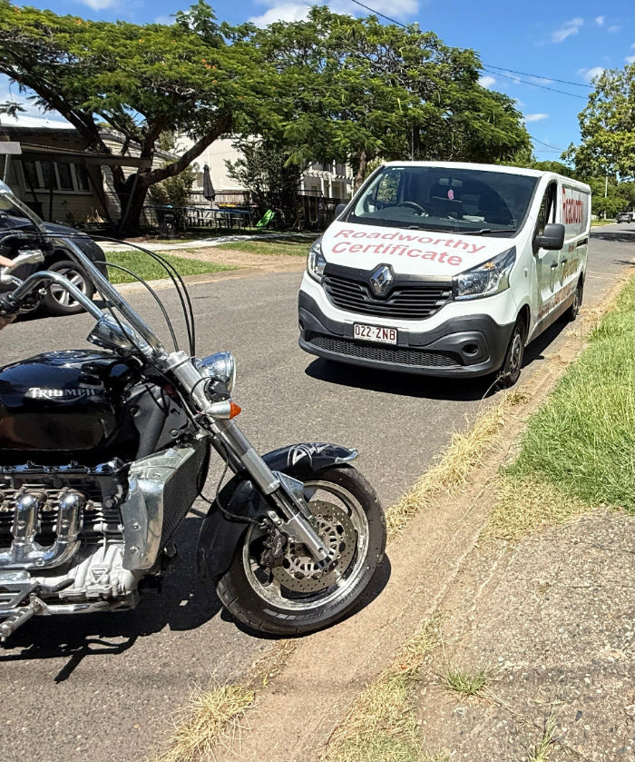 Motorcycle parked on the side of a road with a Roadworthy van in the background in Clontarf