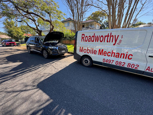 "Our mechanic performing an in-depth engine inspection on an Audi for a Murrumba Downs Mobile Roadworthy (Safety Certificate)."Mobile mechanic van with open car hood on a residential street