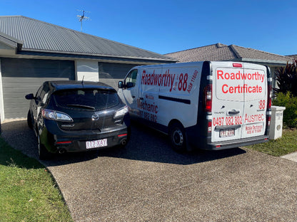 "Convenient Murrumba Downs Mobile Roadworthy (Safety Certificate) being conducted on a customer's car in their driveway by an Ausmec mechanic." Van with Roadworthy branding parked next to a car on a driveway.