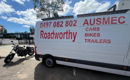 Van with 'AUSMEC' branding and contact number, parked outdoors with a motorcycle nearby in Strathpine