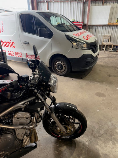 Motorcycle and Roadworthy Van on their sides in a garage in Scarborough