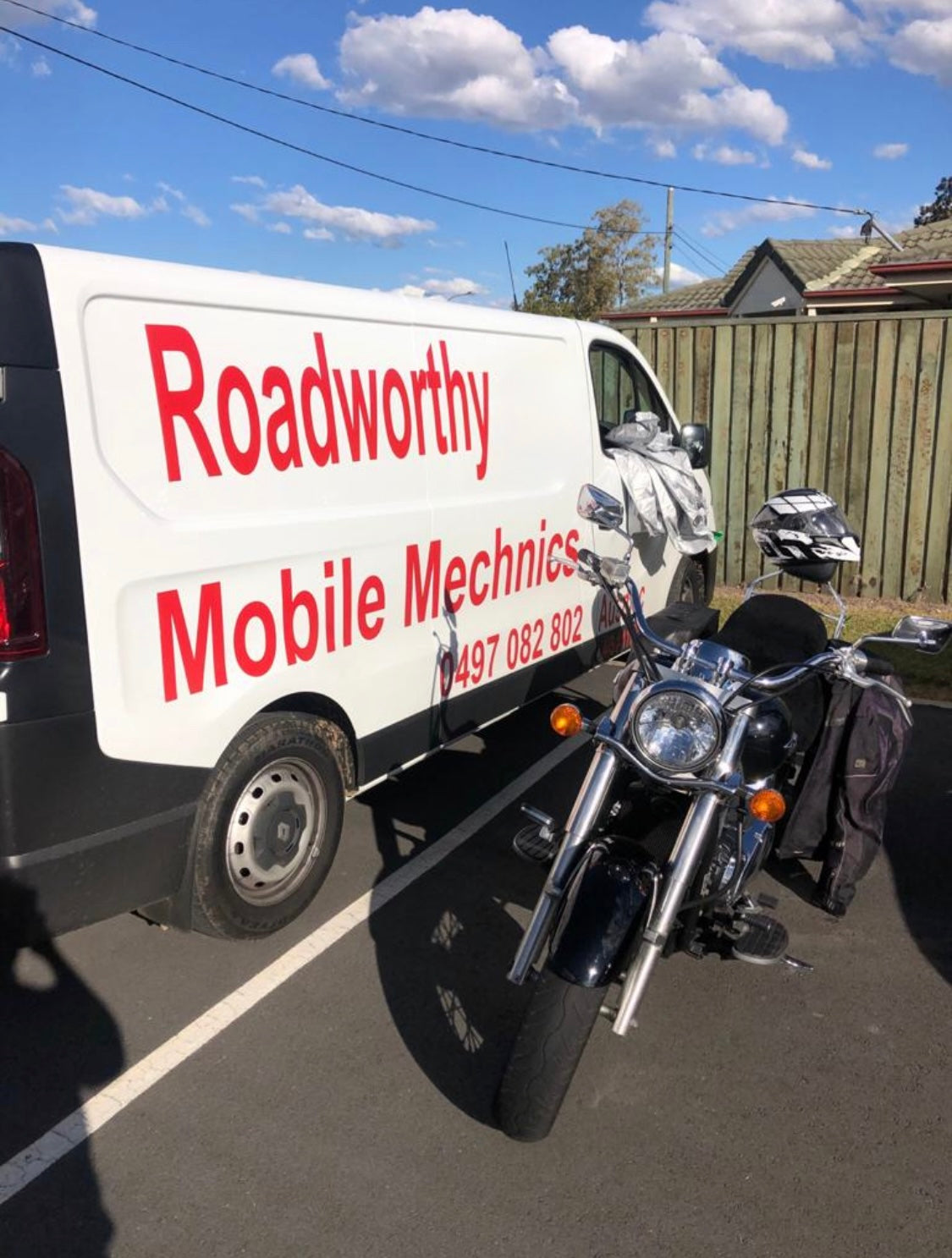 Motorcycle next to a white Van with Red branding 'Roadworthy Mobile Mechanic' in Pinkenbah