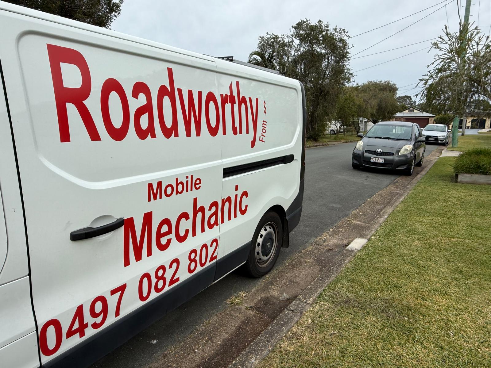 Mobile van ready to inspect: "Ausmec Mobile Roadworthy van, fully equipped and ready to provide a Safety Certificate inspection in Woody Point." White van with 'Roadworthy Mobile Mechanic' branding on a residential street.